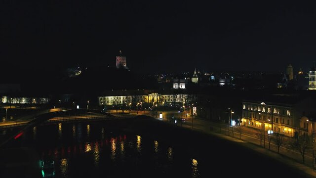Vilnius Old Town at night of independence day. Aerial wide shot of cityscape.