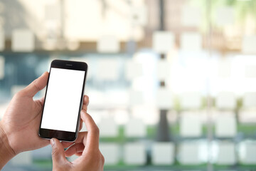 Mock up smartphone of hand holding black mobile phone with blank white screen.