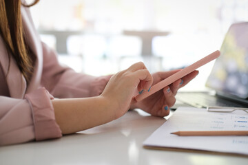 woman using smart phone and tablet for work at home office.