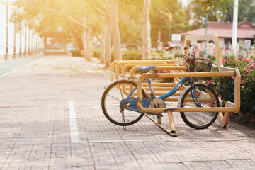 An old bicycle parked in a lane for a bicycle in the park.