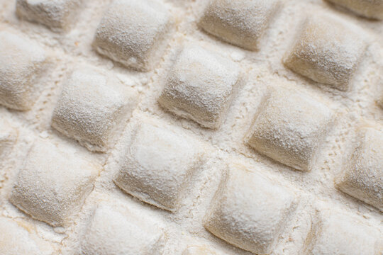 Raw italian ravioli closeup. Homemade pasta ready to be cooked