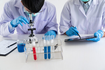 Team of Medical Research Scientists or researcher in lab coat testing their experimental in Modern...