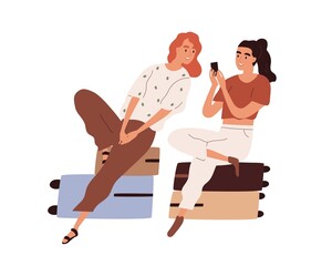 Couple of tourists with luggage waiting for flight. Passengers sitting on suitcases and looking photos in mobile phone. Colored flat cartoon vector illustration of women isolated on white background