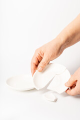 Broken ceramic plate on pure white background