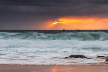 Fototapeta na wymiar A moody overcast sunrise seascape