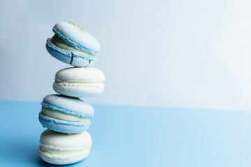 White and blue macaroons on the table, macaroons on white blue background