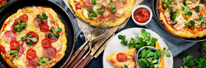 Delicious fresh pizzas variety with different souces and vegetables. Homemade food concept.