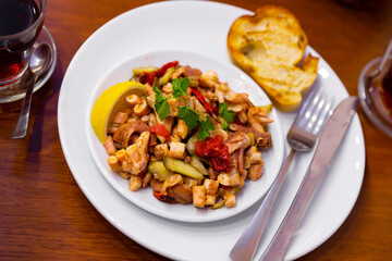 Ahtapot salatasi, traditional turkish octopus salad with vegetables and lemon