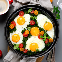 Fried eggs in frying pan for breakfast. Grey background