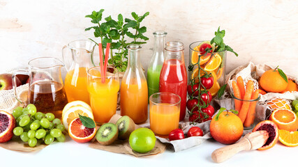 Healthy home made juices and fruits on light wooden background