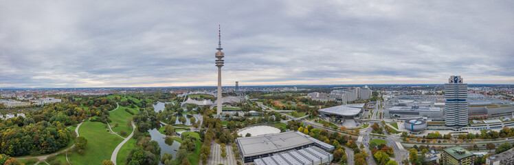 Obraz premium Panoramic aerial view over Munich, typical and authentic pano shot over the green olympic park, modern living at it's best.