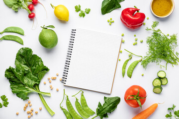 Blank notepad with ingredients for preparing tasty and healthy food on white background