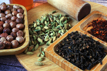Grains of cardamom, clove buds and nuts