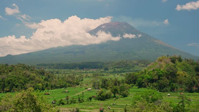 Volcano Agung or Gunung Agung the highest mountain height 3,031 meters above sea, located in the district of Karangasem and surrounded by picturesque rice terraces Bali, Indonesia. 4K UHD Video clip.