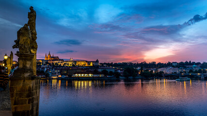 A view across the Charles Bridge and the Vltava River to Prague Castle and St. Vitas Cathedral in Prague, Czech Republic.