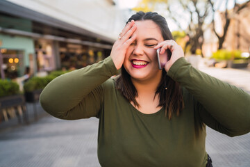 Young plus size woman talking on the phone.