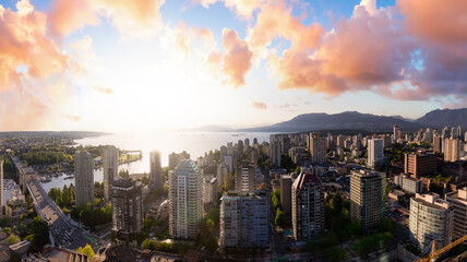 Aerial panoramic view of a beautiful modern city on the Pacific West Coast. Colorful Sunset Sky Art Render. Taken in Downtown Vancouver, British Columbia, Canada. Cityscape Buildings
