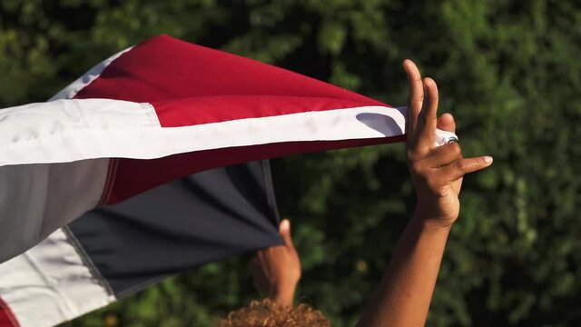 Hands holding a waving flag