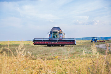 old combine harvester harvests from the field