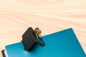 the concept of information protection a closed lock with keys hangs on a notebook for notes