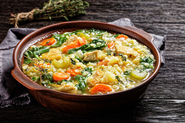 chicken kale veggies soup in a bowl