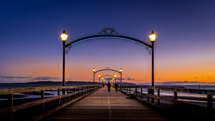 Fototapeta na wymiar Blue Hour over Canada's Longest Pier in Semiahmoo Bay at the village of White Rock in British Columbia, Canada
