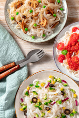 Konjac pasta dishes with various vegetable toppings, overhead flat lay shot