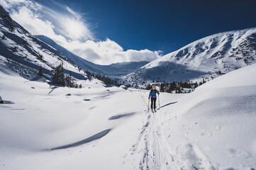 Mountaineer backcountry ski walking ski alpinist in the mountains. Ski touring in alpine landscape...