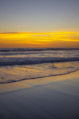 Yellow sunset on the beach. Seascape for background. Colorful sky. Beautiful water reflection. Sunlight on horizon line. Nature and environment concept. Copy space. Sunset in Bali.