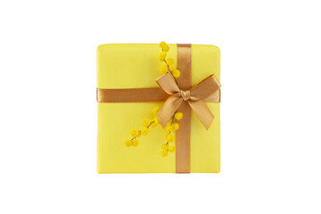 Yellow gift box with ribbon bow and mimosa flowers isolated on white.