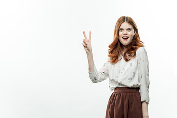 pretty woman with red hair in suit gesturing with hands studio