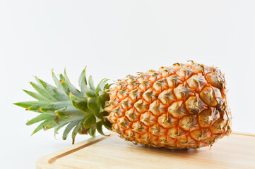 Fresh pineapple on wooden chopping board. Tropical fruit.