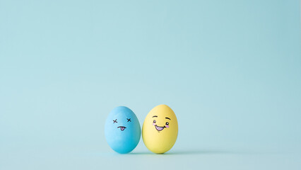 Bipolar disorder. Mental health. Mood swing. Depression therapy. Blue exhausted tired sad yellow happy amused egg couple isolated on conceptual background with empty space.
