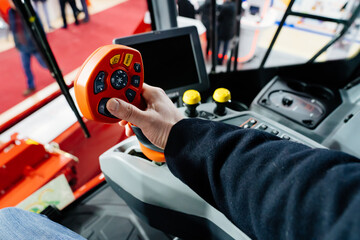 focus on joystick.Multifunctional lever in control cabin of agricultural combine © Maria