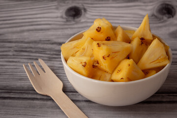 Pineapple skin removed and sliced into small pieces. Pineapple is healthy and good in vitamins. Use for healthy snack concept.