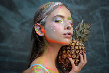 Abstract summer makeup. Pineapple fruit. Fashion girl with colorful powder make up. Colourful...