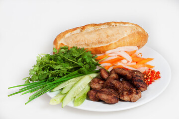 Famous Vietnamese food is banh mi thit, popular street food from bread stuffed with raw material: grilled pork and fresh herbs as scallions, coriander, carrot, cucumber, chilli. On White