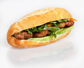 Famous Vietnamese food is banh mi thit, popular street food from bread stuffed with raw material: grilled pork and fresh herbs as scallions, coriander, carrot, cucumber, chilli. On White