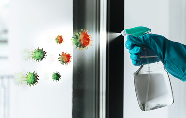 Person sanitizing glass with antiseptic spray, killing viruses