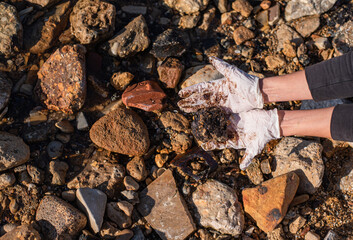 Dirty gloves from oil. Coastal pollution by emissions from oil spills on sea. People collect this dangerous rubbish. Oil spills cause great harm to nature, marine animals and birds die. Eco system.