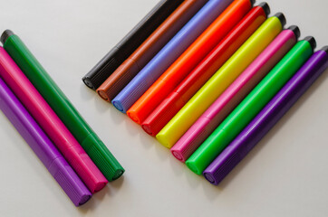 Colorful multi-colored felt-tip pens on a white background.