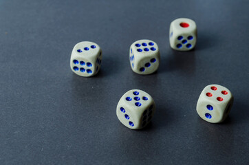 Old dice on a gray background.