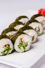 Maki Sushi - Roll made of smoked salmon and cream cheese. Traditional Japanese cuisine concept, over white background.