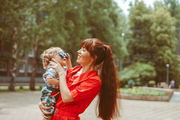 Naklejka premium mom holds her son in her arms