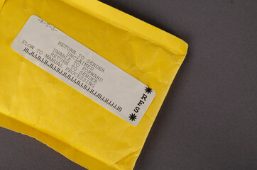 A yellow mail bag that says RETURN TO SENDER.