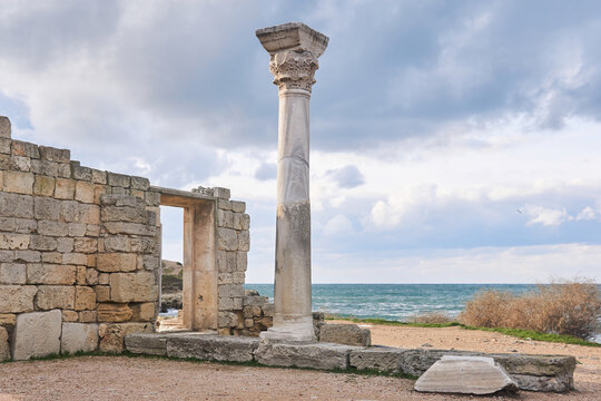 ruins of antique greek temple with column on the seashore