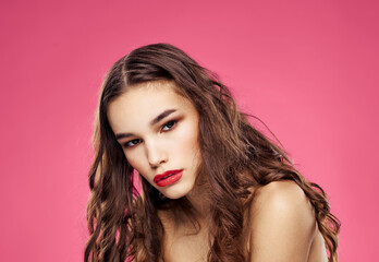 Fototapeta premium Pink background female portrait bared shoulders red lips