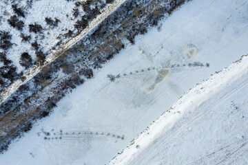 A fisherman fishing in winter time on ice covered river