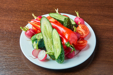 slicing fresh vegetables on a plate