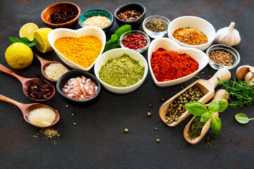 Various spices in a bowls on a black